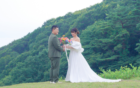 手をつなぎ花束を持つ男女